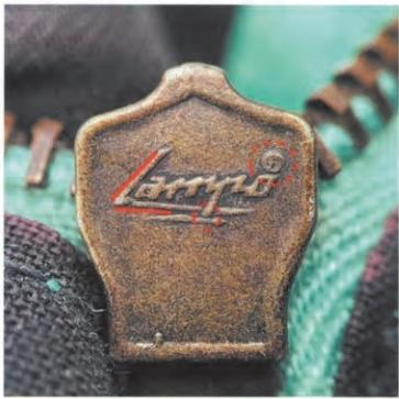 Spotting Fake Designer Bags-Close - up of a Lampo zipper head, featuring the "Lampo" logo engraving.
