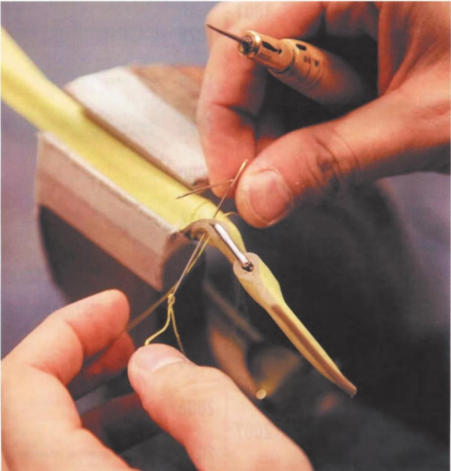 Hermès Replica Bags-It shows the details of Hermès' handmade leather sewing craftsmanship. A pair of hands is using tools to finely sew leather, reflecting the brand's exquisite handmade leather-making skills.