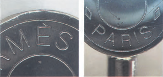 Additional view of authentic metal engraving on Hermès Kelly bag, emphasizing fine detailing on the lock plate.