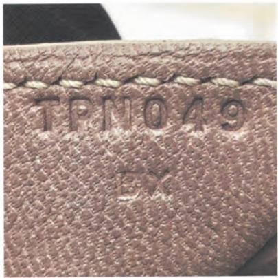 Hermès internal stamp reading "TPNOA9" – authentication detail for luxury bags.
