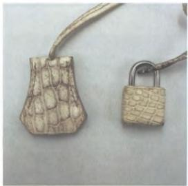 Hermès lock and key mechanism – precision metalwork for luxury bag security.