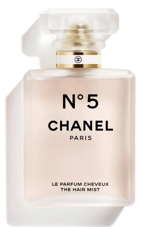 A bottle of Chanel N°5 Le Parfum Cheveux The Hair Mist, showing the translucent pink liquid and iconic minimalistic octagonal bottle, an important component of the Chanel brand history.