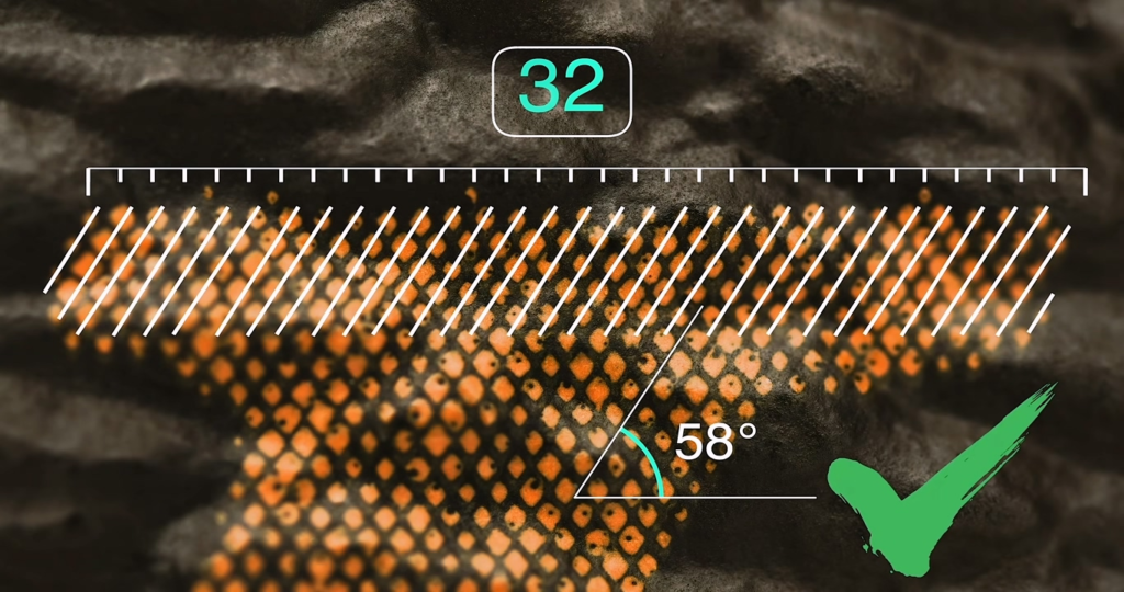 Macro analysis of Ultimate Piece C replica Monogram letter "L" showing successful replication of 32 rows at 58 degrees with precise dot alignment, marked with a green check for cracking the hidden geometric code.